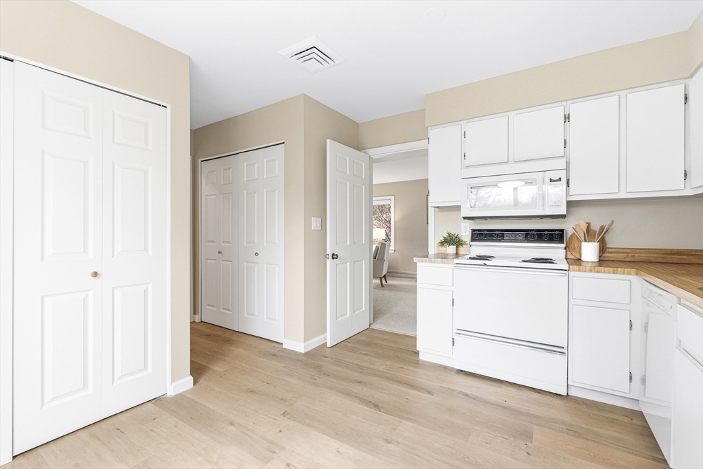 4 Drummer Boy Way, Unit 4 Lexington, MA 02420 - Photo 14 of 37 a kitchen with granite countertop white cabinets and white appliances