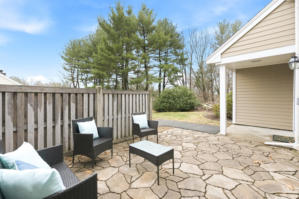 4 Drummer Boy Way, Unit 4 Lexington, MA 02420 - Photo 18 of 37 a view of a chairs and table in backyard of the house