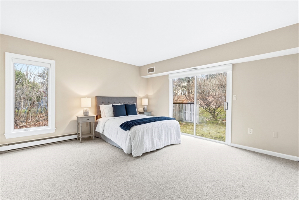 4 Drummer Boy Way, Unit 4 Lexington, MA 02420 - Photo 22 of 37 a spacious bedroom with a bed and a large window