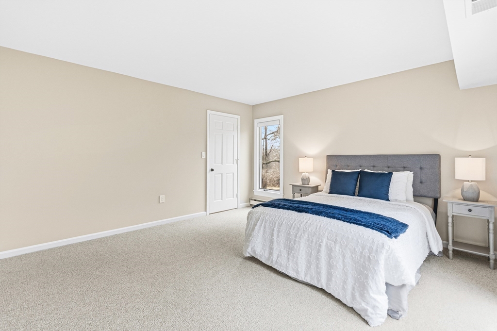 4 Drummer Boy Way, Unit 4 Lexington, MA 02420 - Photo 23 of 37 a bedroom with a bed and a night stand