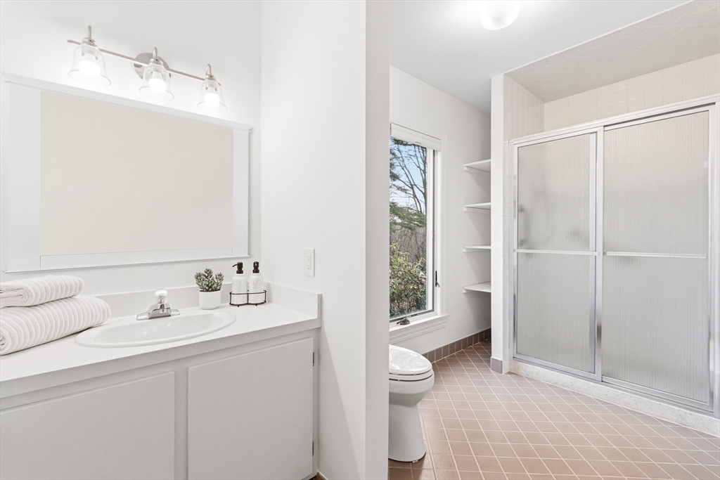 4 Drummer Boy Way, Unit 4 Lexington, MA 02420 - Photo 25 of 37 a bathroom with a sink a toilet and shower