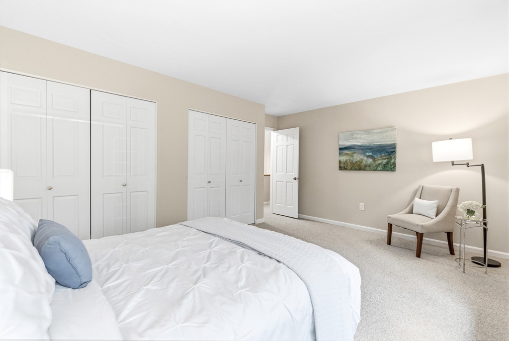 4 Drummer Boy Way, Unit 4 Lexington, MA 02420 - Photo 29 of 37 a spacious bedroom with a bed and a couch