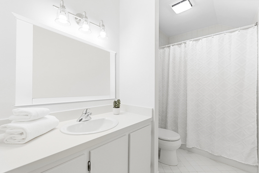 4 Drummer Boy Way, Unit 4 Lexington, MA 02420 - Photo 33 of 37 a bathroom with a sink toilet and vanity