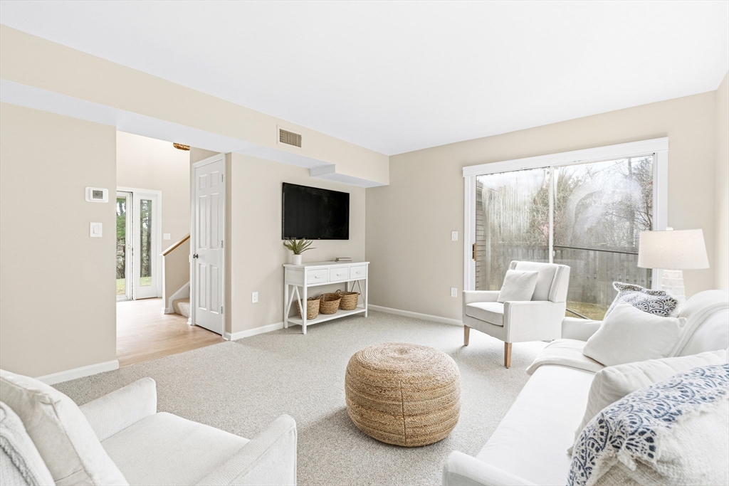 4 Drummer Boy Way, Unit 4 Lexington, MA 02420 - Photo 4 of 37 a living room with furniture and a flat screen tv
