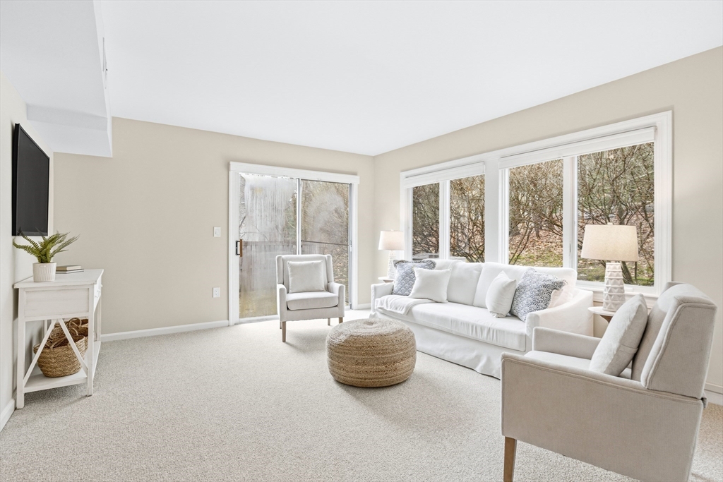 4 Drummer Boy Way, Unit 4 Lexington, MA 02420 - Photo 5 of 37 a living room with furniture and a flat screen tv