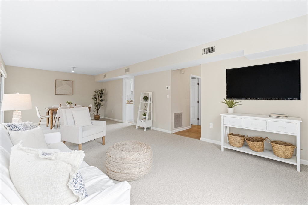 4 Drummer Boy Way, Unit 4 Lexington, MA 02420 - Photo 7 of 37 a living room with furniture and a flat screen tv