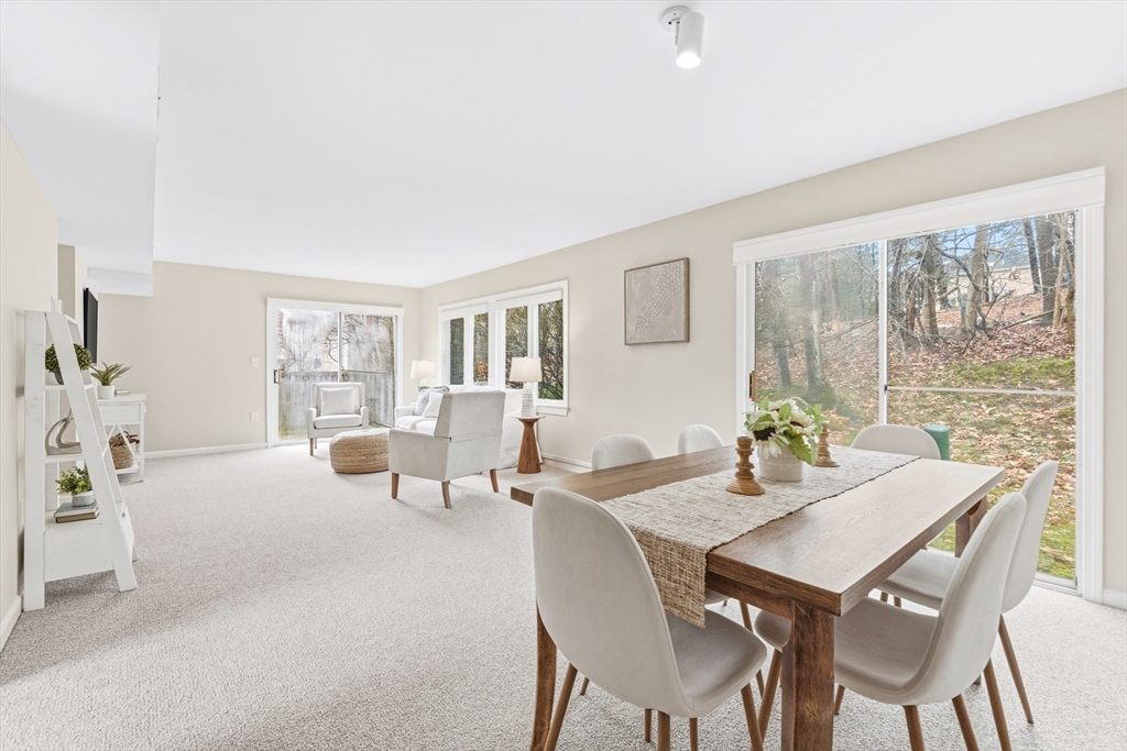 4 Drummer Boy Way, Unit 4 Lexington, MA 02420 - Photo 10 of 37 a view of a dining room with furniture and a potted plant