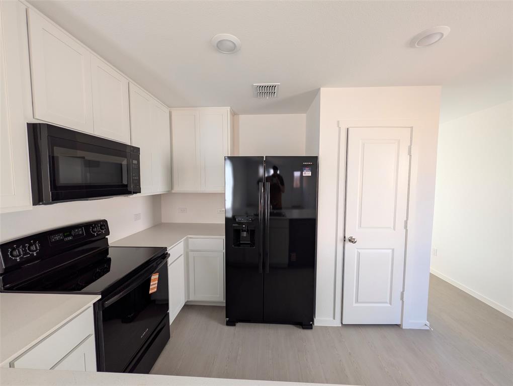 802 Sandhill Crane Lane Princeton, TX 75407 - Photo 5 of 18 a kitchen with a refrigerator and a stove