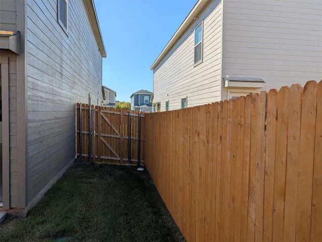 a view of a house with a wooden fence