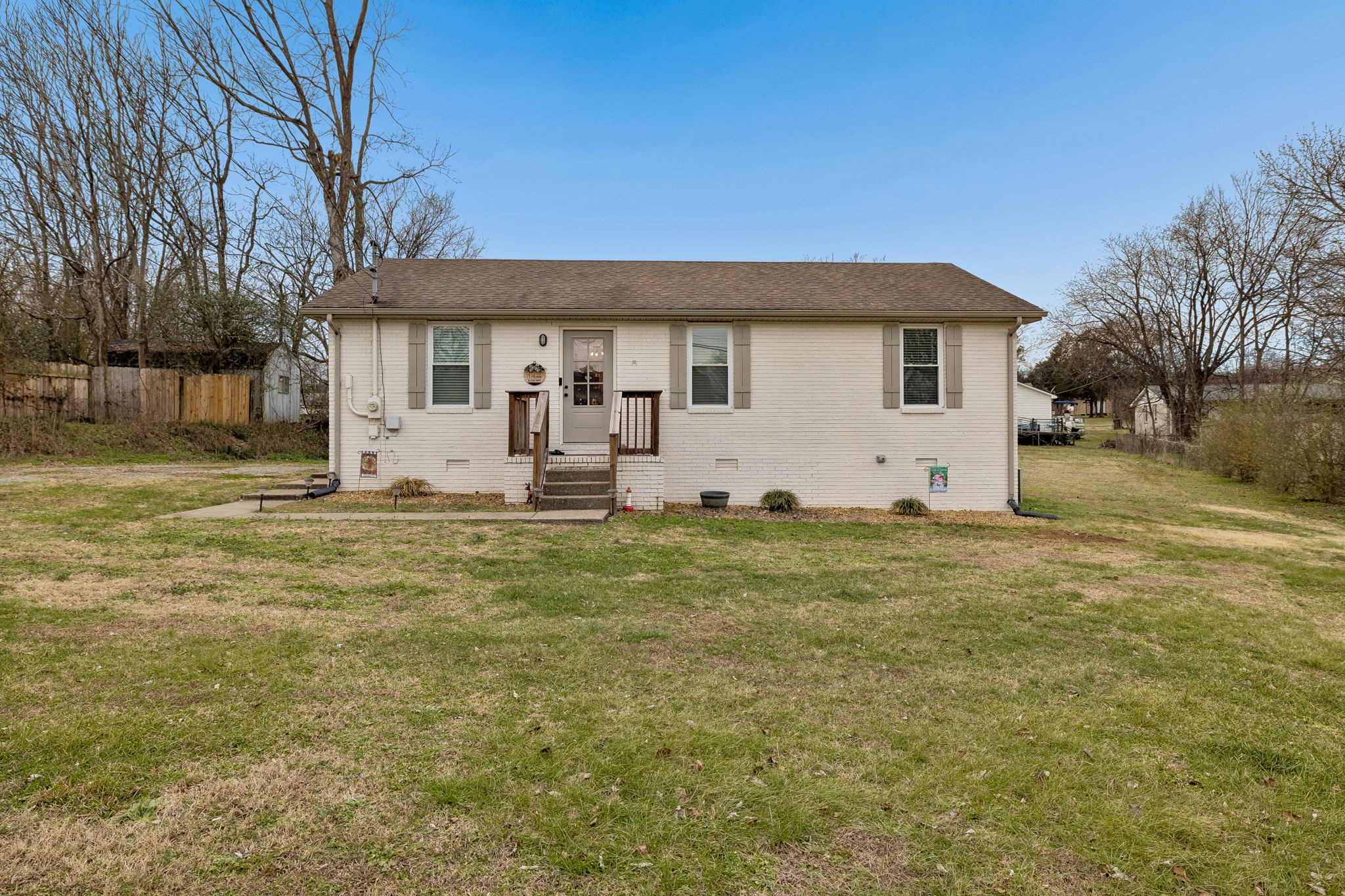 236 Commerce Avenue Watertown, TN 37184 - Photo 31 of 31 a front view of house with yard and trees in the background
