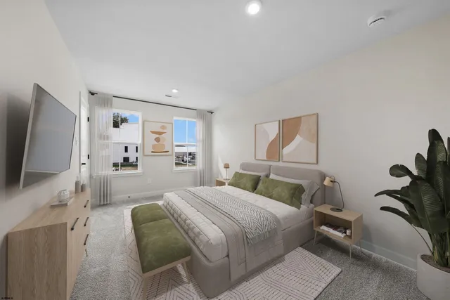 a bedroom with a large bed and a flat tv screen on dresser