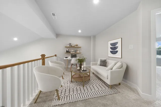 a living room with furniture a rug and a painting