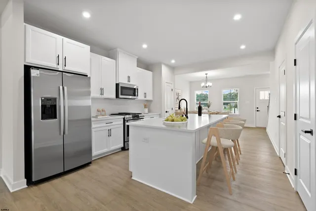 a kitchen with refrigerator and cabinets