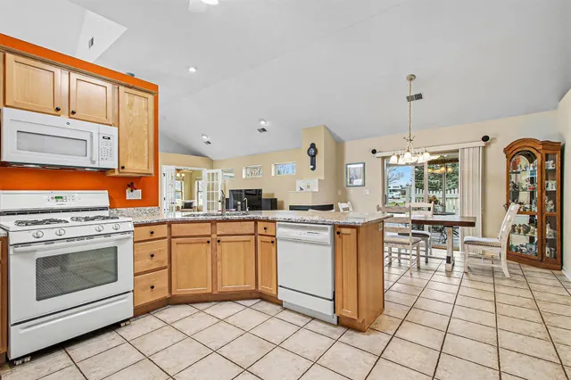 a dining room with furniture wooden floor and a potted plant