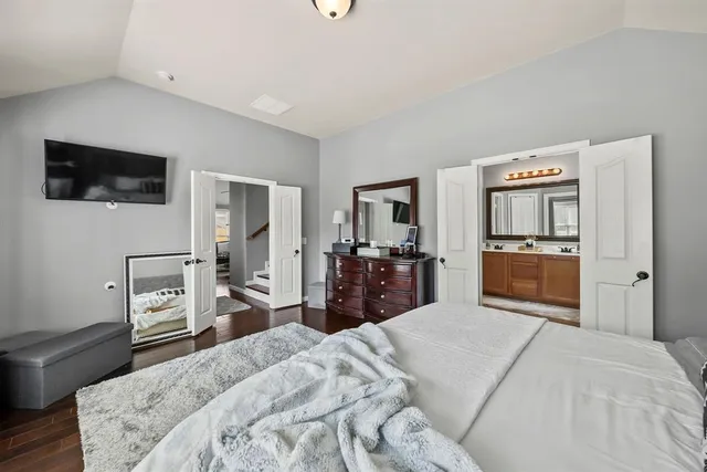 a bedroom with a large bed and a couch