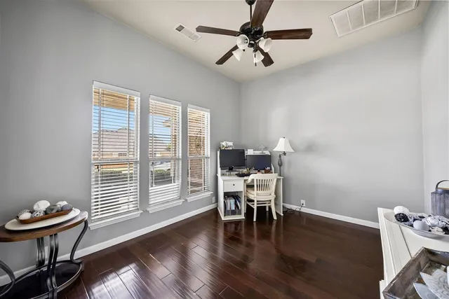 a bedroom with furniture and a flat screen tv