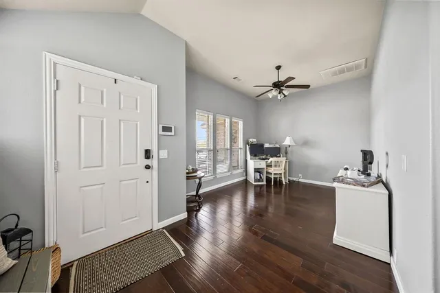 a view of a livingroom with furniture and a ceiling fan