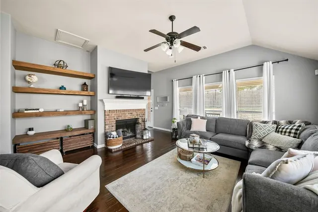 a living room with furniture fireplace and flat screen tv