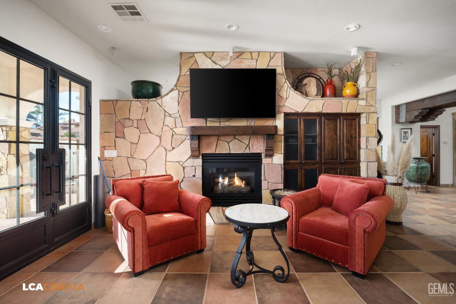 Undisclosed Address Bakersfield, CA 93306 - Photo 46 of 56 a living room with furniture a flat screen tv and a fireplace