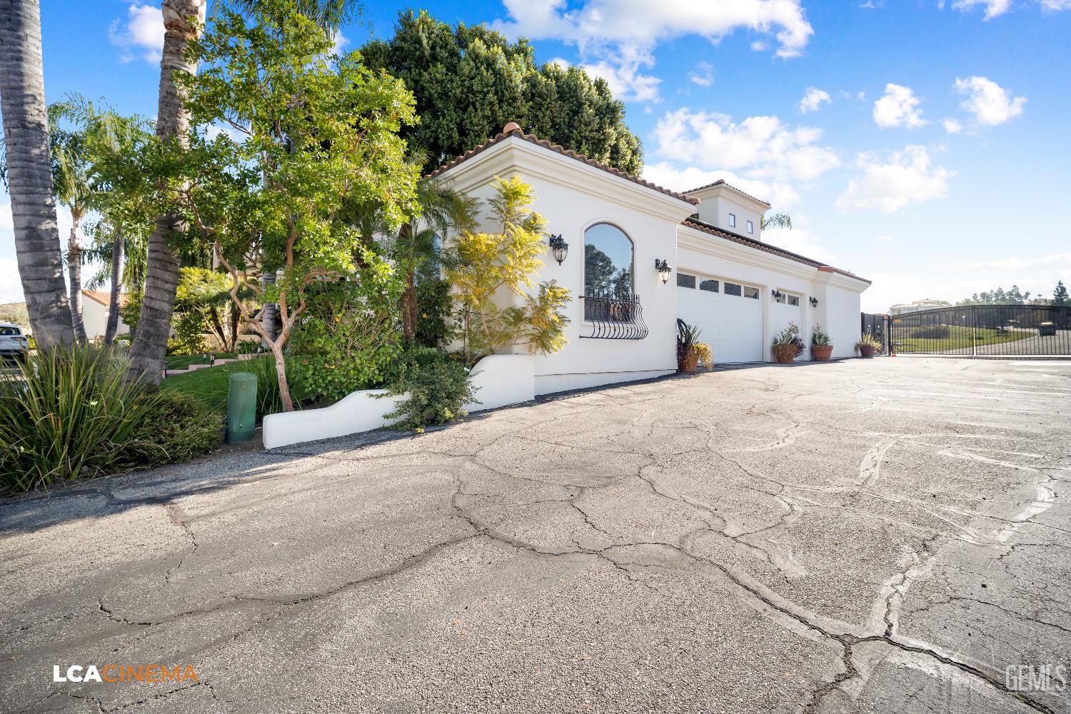 Undisclosed Address Bakersfield, CA 93306 - Photo 49 of 56 a view of a white house with a yard and garage