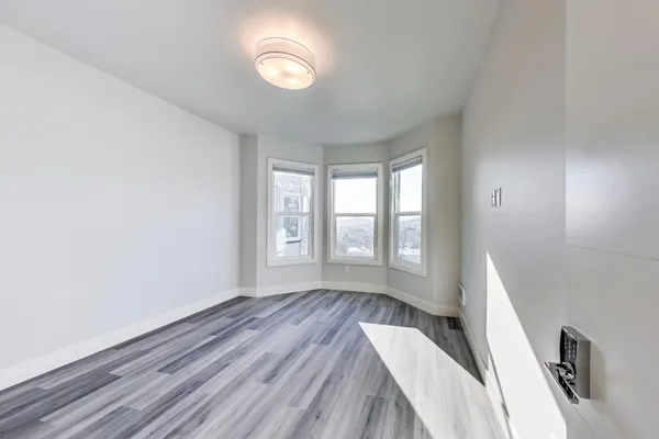 a view of wooden floor and windows in a room