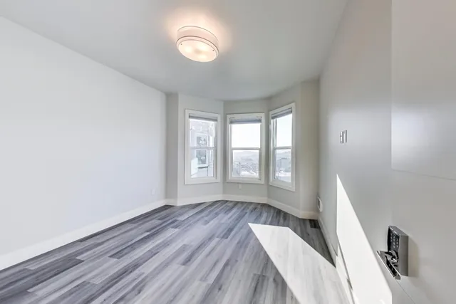 a view of wooden floor and windows in a room