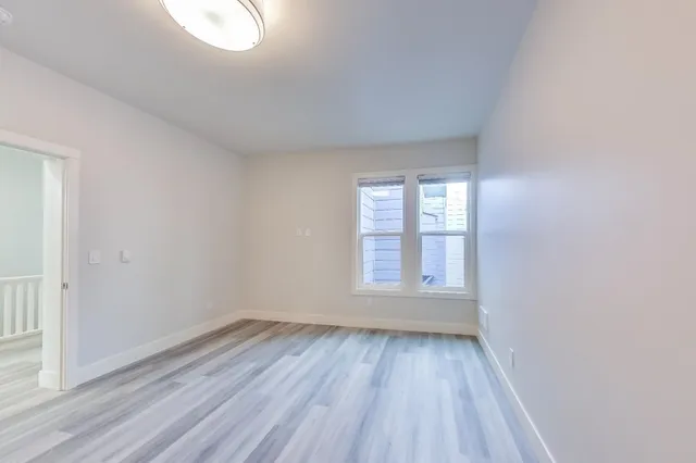 a bathroom with a bathtub shower sink vanity mirror and toilet