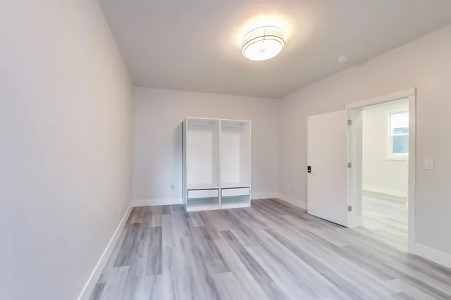 a view of a hallway with wooden floor