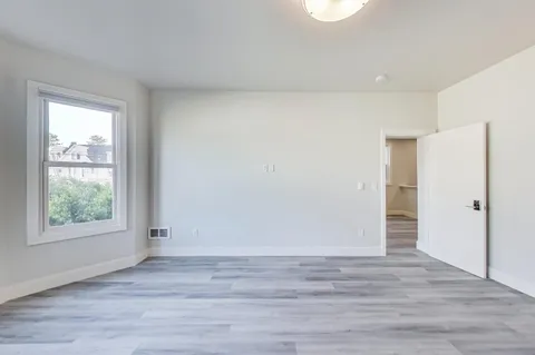 a view of hallway with wooden floor