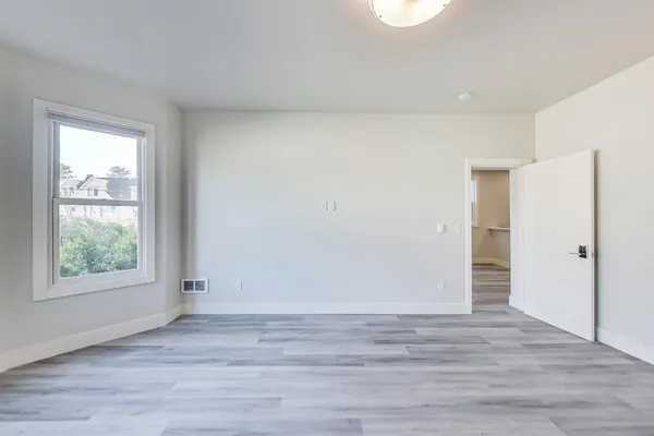 a view of hallway with wooden floor