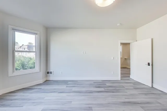 a view of hallway with wooden floor