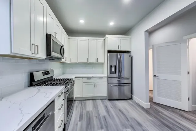 a bedroom with a bed and a view of living room