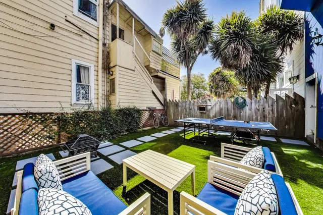 a view of an empty room with wooden floor and window
