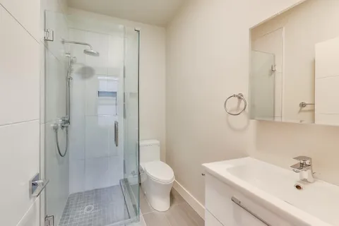 a bathroom with a sink toilet and shower