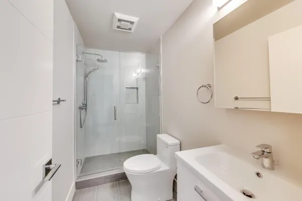 a bathroom with a sink toilet and shower