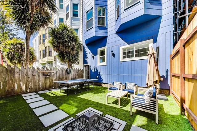 a view of an empty room with wooden floor and closet