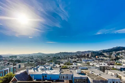 a view of a room with wooden floor and white walls