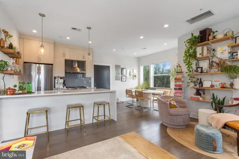 a large kitchen with a table and chairs