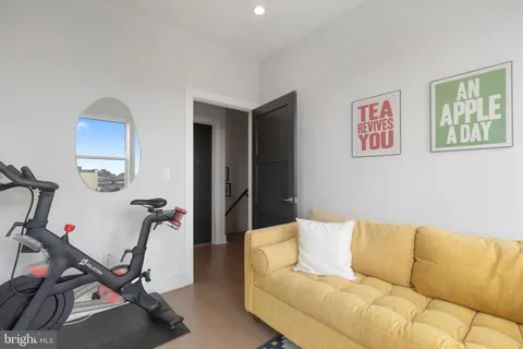 a living room with furniture a flat screen tv and a window