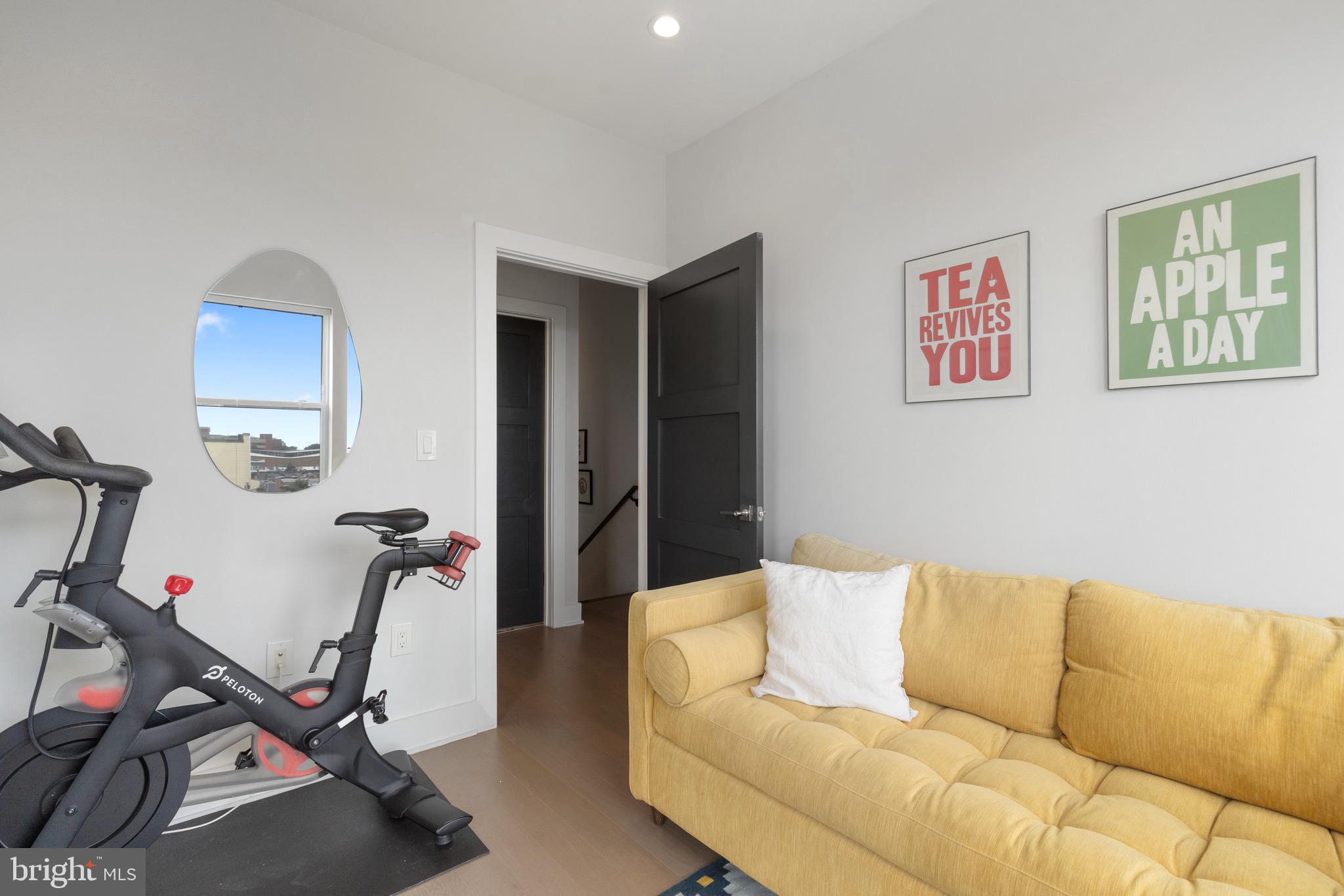 653 Irving Street Northwest, Unit 7 Washington, DC 20010 - Photo 23 of 31 a living room with furniture a flat screen tv and a window