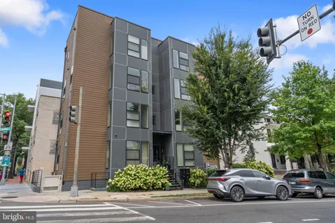 a couple of cars parked in front of brick building