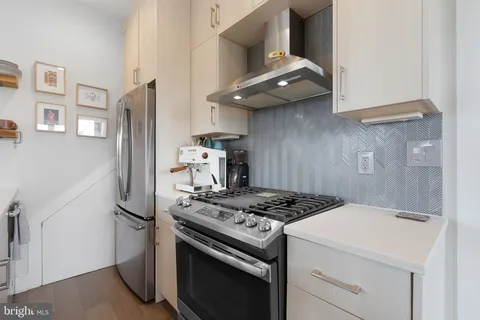 a kitchen with stainless steel appliances granite countertop a stove and a refrigerator