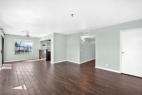 a view of an empty room with wooden floor
