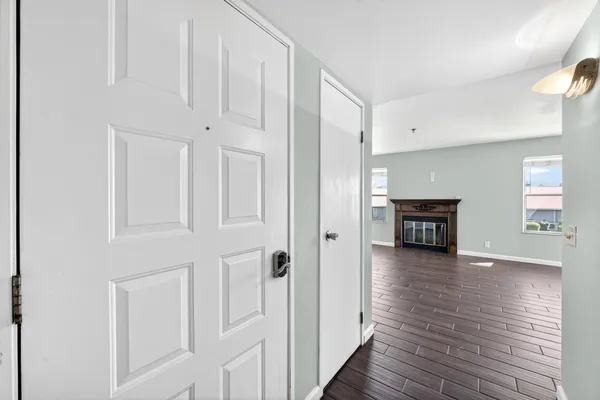 a view of an empty room with wooden floor