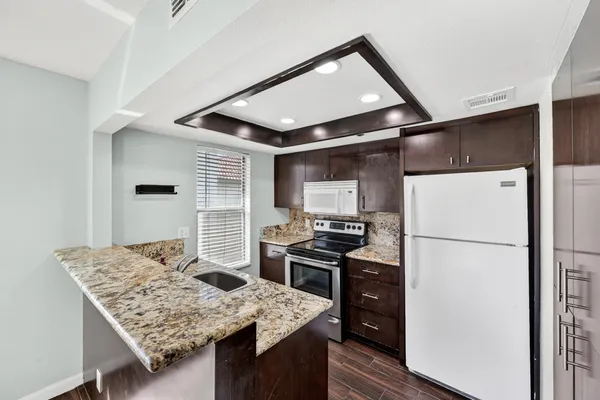 a kitchen with a stove a refrigerator and a refrigerator