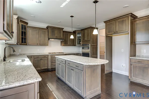 a kitchen that has a sink a stove and a refrigerator