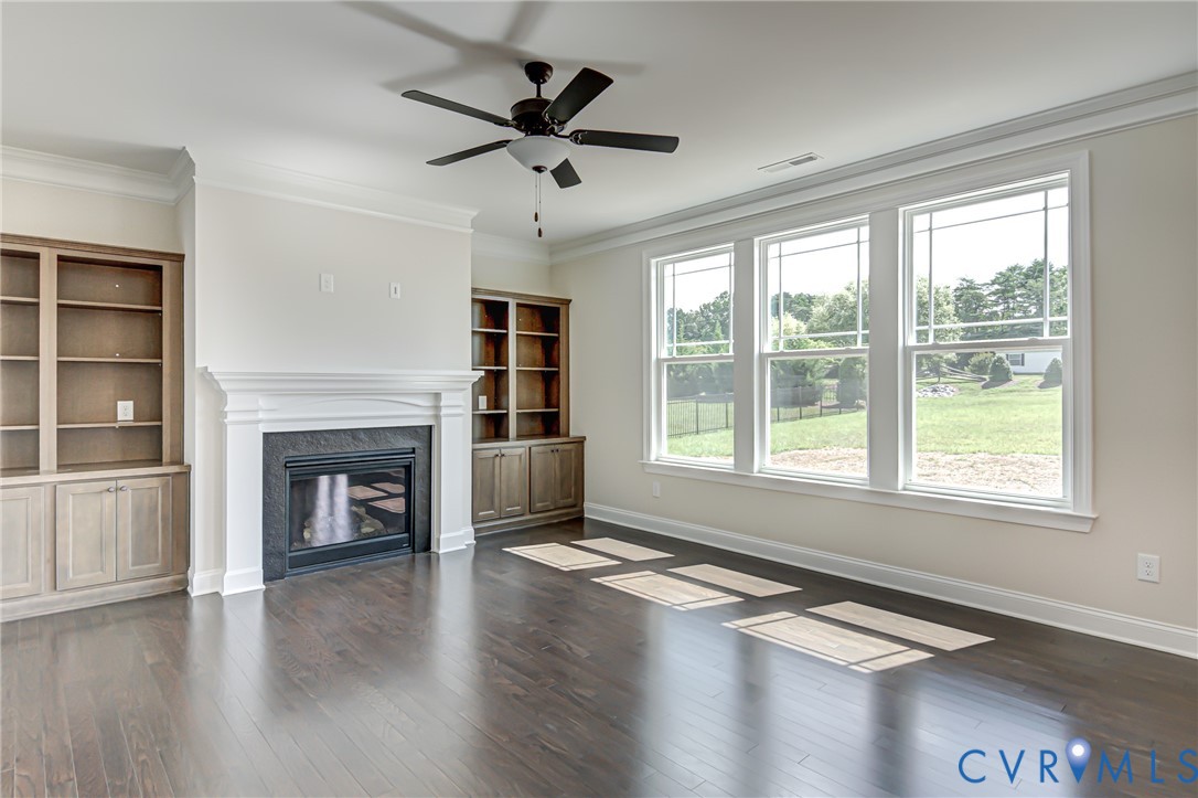11366 Pinewild Drive Providence Forge, VA 23140 - Photo 5 of 22 a view of an empty room with wooden floor and a window