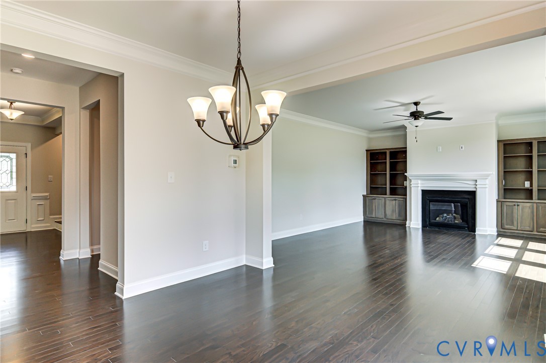 11366 Pinewild Drive Providence Forge, VA 23140 - Photo 9 of 22 a view of a livingroom with a chandelier fireplace and wooden floor