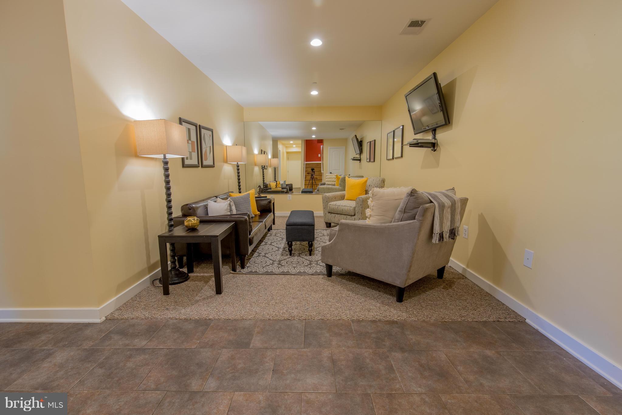 309 Willington Drive Silver Spring, MD 20904 - Photo 27 of 30 a living room with furniture and a flat screen tv