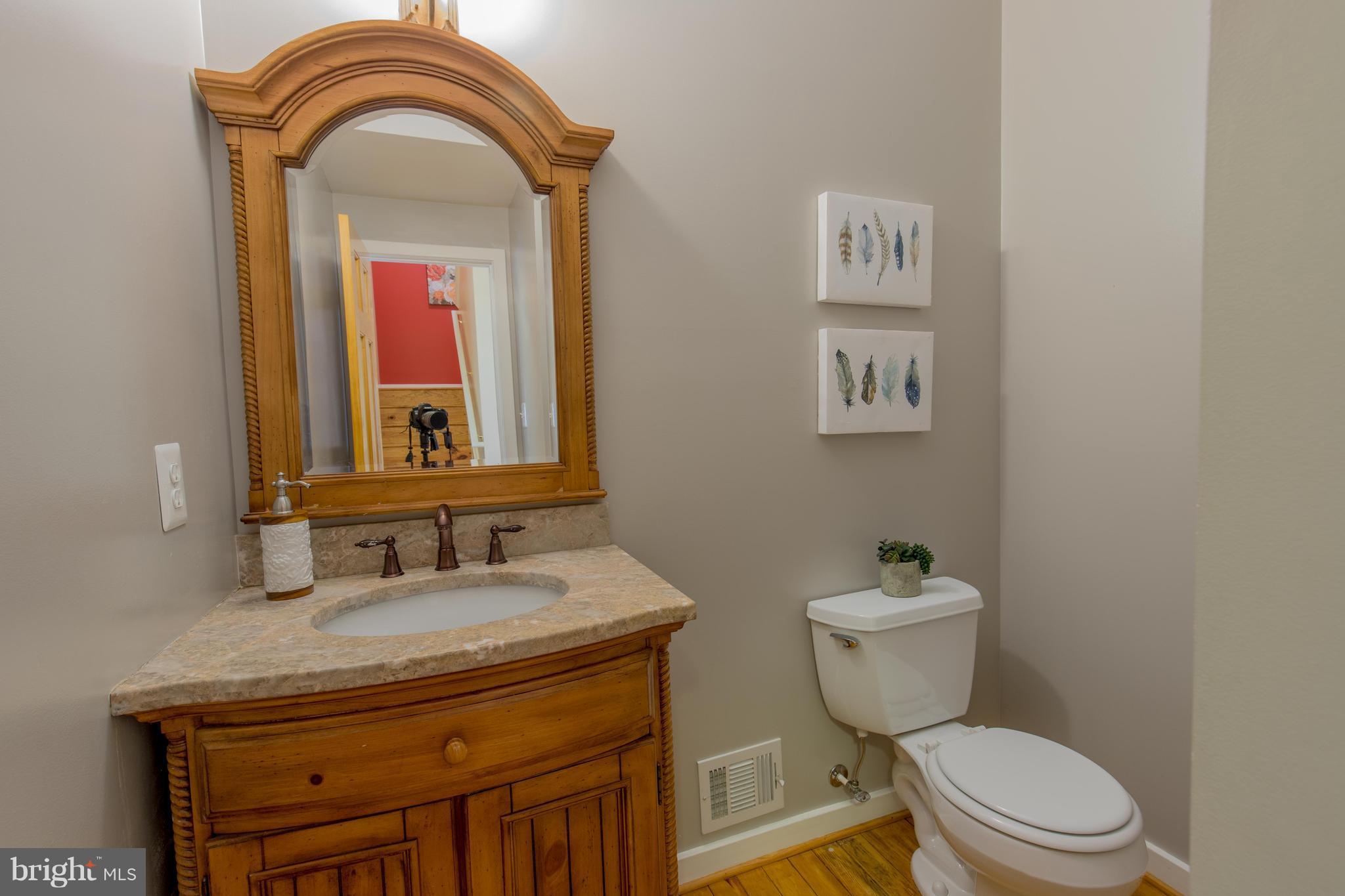 309 Willington Drive Silver Spring, MD 20904 - Photo 8 of 30 a bathroom with a toilet a sink and mirror